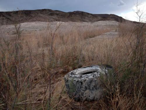 LAKE MEAD NATIONAL RECREATION AREA, NEVADA - AUGUST 18: A tire sits the ground in a section of Lake Mead that was previously under water near Echo Bay on August 18, 2022 in Lake Mead National Recreation Area, Nevada. The federal government announced plans to cut water allocations from the Colorado River Basin to Arizona and Nevada for the second year in a row and is asking residents to cut water consumption as the drought worsens. Water levels at Lake Mead stand at 27 percent of capacity, its lowest level since being filled in the 1930s following the construction of the Hoover Dam. The lake's water levels have fallen an estimated 175 feet since 2000.  (Photo by Justin Sullivan/Getty Images)