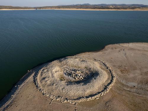CACERES, SPAIN - JULY 28: The Dolmen of Guadalperal, sometimes also known as "The Spanish Stonehenge" is seen above the water level at the Valdecanas reservoir, which is at 27 percent capacity, on July 28, 2022 in Caceres province, Spain. Some areas of Europe are at risk of drought following a lack of precipitation and severe heatwaves. Spain is battling one of the driest weather conditions in a long time, which could lead to implications for agriculture and tourism, with some areas already facing water restrictions. (Photo by Pablo Blazquez Dominguez/Getty Images)