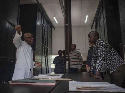 Elasi Ramazani (L), 69, director of the Yangambi Herbarium and a scientist for nearly 25 years, talks with other scientists in the room where they study herbs in Yangambi, 100 km from the city of Kisangani, Tshopo province, northeastern Democratic Republic of Congo, on September 2, 2022. - The site, renowned during the time of Belgian colonisation for its research in tropical agronomy, hosts a herbarium that has more than 6000 species. (Photo by Guerchom Ndebo / AFP)