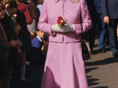 British Royal Queen Elizabeth ll, wearing a lilac suit with a checked collar and matching turban-style hat, during a walkabout in Wellington, New Zealand, 27th February 1977. The visit is part of the Queen's Silver Jubilee tour. (Photo by Serge Lemoine/Hulton Archive/Getty Images)