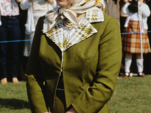 British Royal Queen Elizabeth II, wearing a green coat with a headscarf, attends a polo match, location unspecified, 1981. (Photo by Serge Lemoine/Hulton Archive/Getty Images)