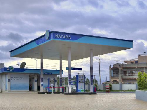 This photograph taken on July 13, 2022 on the outskirts of Bangalore, India, shows a Nayara Energy Limited petrol station. - A vintage pump in the Vietnamese hills; a Madrid petrol station topped with a giant sombrero; a multi-coloured futuristic fuel outlet in Dubai  whatever its form the humble filling stop, emblem of our modern societies, would appear to be running out of road. (Photo by Manjunath KIRAN / AFP)