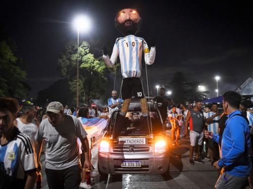 BUENOS AIRES, ARGENTINA - DECEMBER 19: Fans of Argentina display a Lionel Messi figure outside Argentina's training ground before the arrival of the Argentina men's national football team after winning the FIFA World Cup Qatar 2022 on December 20, 2022 in Buenos Aires, Argentina. (Photo by Rodrigo Valle/Getty Images)