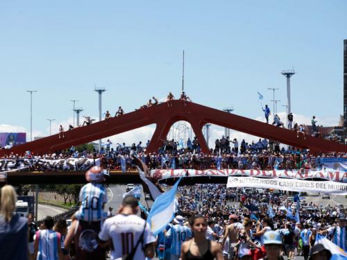 Fans of Argentina wave flags as part of celebrations awaiting a victory parade of the Argentina men's national football team after winning the FIFA World Cup Qatar 2022 on December 20, 2022 in Buenos Aires, Argentina. (Photo by Carol Smiljan/NurPhoto via Getty Images)
