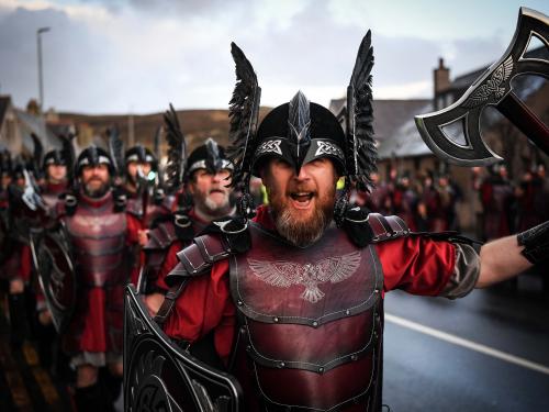 Members of the Up Helly Aa 'Jarl Squad' parade through the streets in Lerwick, Shetland Islands on January 31, 2023 before the Up Helly Aa festival later in the day. - Up Helly Aa celebrates the influence of the Scandinavian Vikings in the Shetland Islands and culminates with up to 1,000 'guizers' (men in costume) throwing flaming torches into their Viking longboat and setting it alight later in the evening. (Photo by Andy Buchanan / AFP)