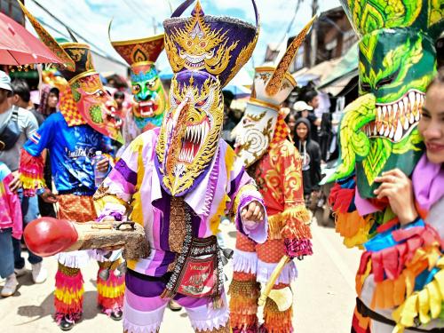 Participants wearing ghost masks and colorful costumes take part in parade during the annual Phi Ta Khon carnival or ghost festival in Dan Sai district in northeastern Thailands Loei Province on June 24, 2023. (Photo by MANAN VATSYAYANA / AFP)