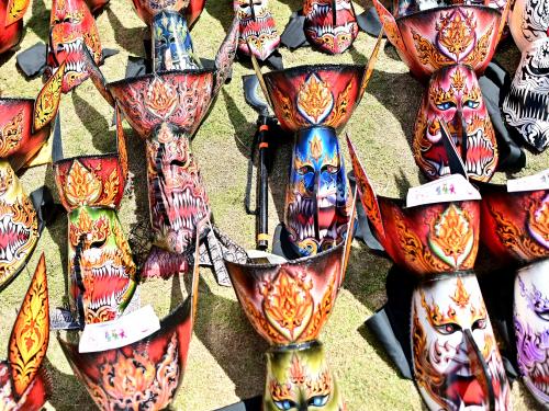 Elaborate long-nosed ghost masks are seen on the ground ahead of a parade during the annual Phi Ta Khon carnival or ghost festival in Dan Sai district in northeastern Thailands Loei Province on June 24, 2023. (Photo by MANAN VATSYAYANA / AFP)