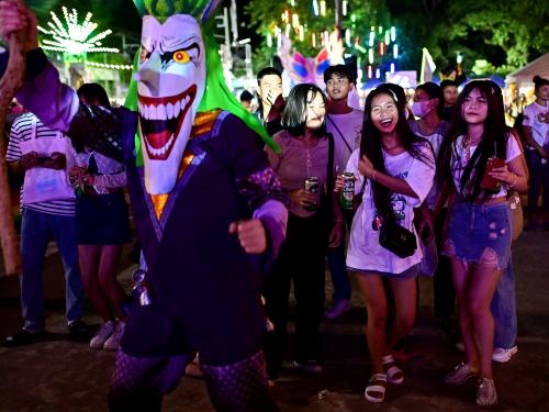 This photo taken on June 23, 2023 shows festival-goers attending the annual Phi Ta Khon carnival or ghost festival in Dan Sai district in northeastern Thailands Loei Province. (Photo by MANAN VATSYAYANA / AFP)