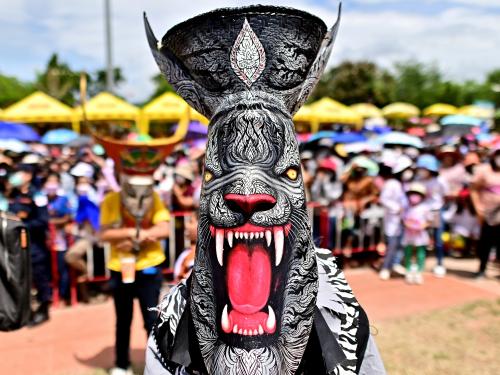 A participant wearing a ghost mask and colorful costume takes part in the annual Phi Ta Khon carnival or ghost festival in Dan Sai district in northeastern Thailands Loei Province on June 24, 2023. (Photo by MANAN VATSYAYANA / AFP)