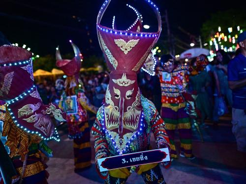 This photo taken on June 23, 2023 shows festival-goers wearing ghost masks and colorful costumes while dancing at night during the annual Phi Ta Khon carnival or ghost festival in Dan Sai district in northeastern Thailands Loei Province. (Photo by MANAN VATSYAYANA / AFP)