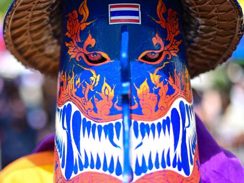A participant wearing a ghost mask and colorful costume takes part in the annual Phi Ta Khon carnival or ghost festival in Dan Sai district in northeastern Thailands Loei Province on June 24, 2023. (Photo by MANAN VATSYAYANA / AFP)