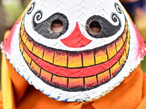 A participant wearing a ghost mask and colorful costume takes part in the annual Phi Ta Khon carnival or ghost festival in Dan Sai district in northeastern Thailands Loei Province on June 24, 2023. (Photo by MANAN VATSYAYANA / AFP)