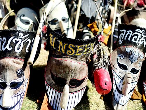 Elaborate long-nosed ghost masks are seen on the ground ahead of a parade during the annual Phi Ta Khon carnival or ghost festival in Dan Sai district in northeastern Thailands Loei Province on June 24, 2023. (Photo by MANAN VATSYAYANA / AFP)