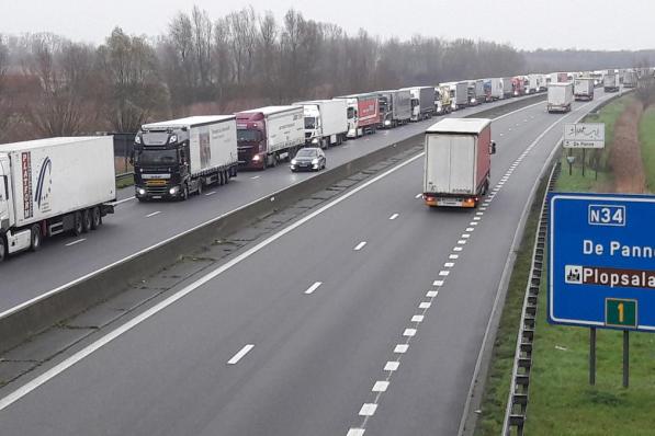 Op de E40 in Adinkerke staan de vrachtwagens kilometerslang aan te schuiven. (José Tyteca)