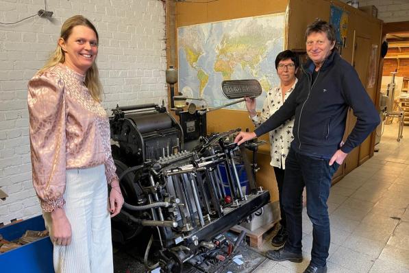 V.l.n.r. herkennen we dochter Greet, echtgenote Ria en drukker Fred bij z'n eerste drukmachine, met letters in lood. (foto AVH)