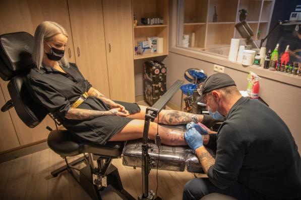 Joy Vanmellaerts wordt onder handen genomen door tattoo-artist Andrew.© Wouter Meeus
