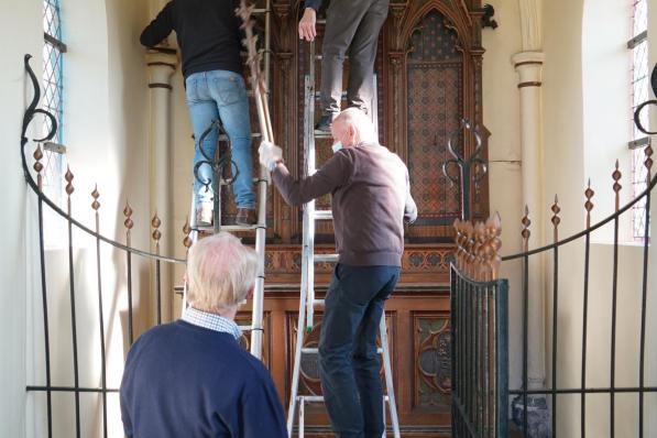 Leden van Mulenbeca helpen bij de ontmanteling van het altaar in de kapel.© Luc
