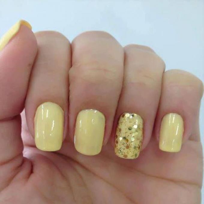 Gele pastelnagels met gouden glitters
