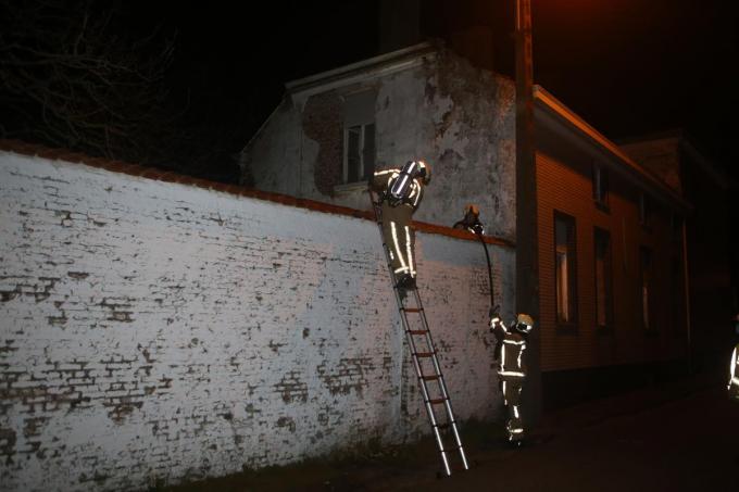 De brandweerlui plaatsten een ladder tegen de hoge tuinmuur in de Kruisstraat.© NDZ