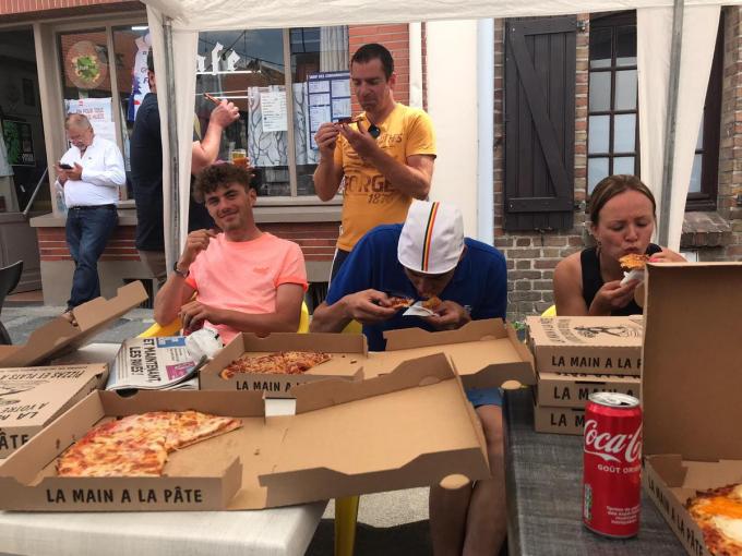 De mannen en vrouwen van Forza Lampaert genieten van een lekkere pizza.