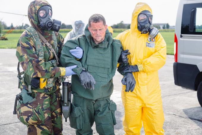 Een Nederlands en Italiaans team ondersteun een simulant naar de ambulance.