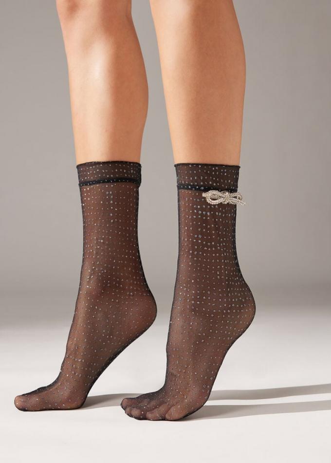 Korte sokken van tule met glitterstippen en strikje