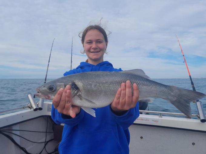 Kato Lowagie, nu 14 jaar, met een mooie zeebaars op de boot van papa Hans. (foto JTV)
