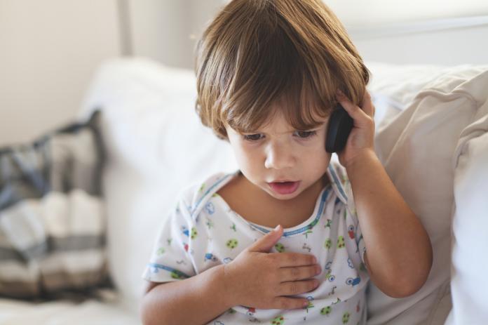 Small boy talking on mobile phone