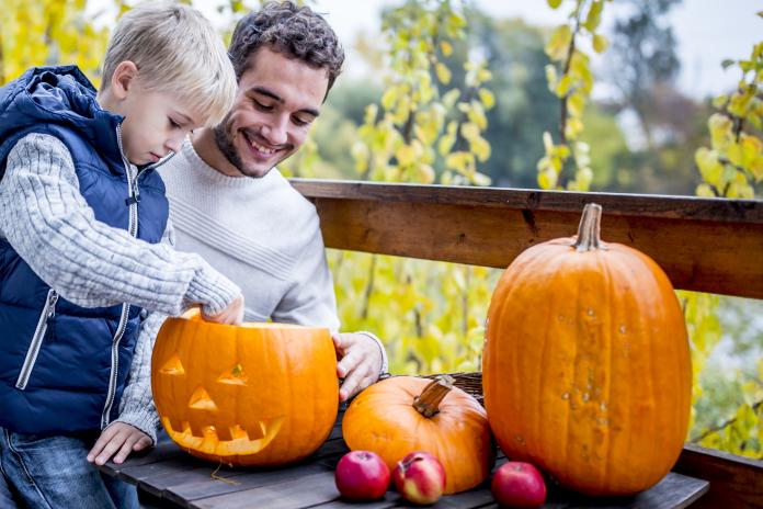 Father and son with Halloween pumpkin