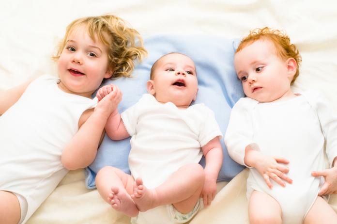 2 babies and 1 toddler laying down