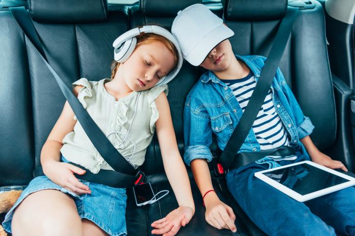 kids sleeping on backseats of car