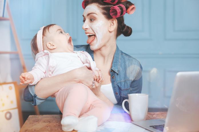Happy delighted woman having fun with her daughter