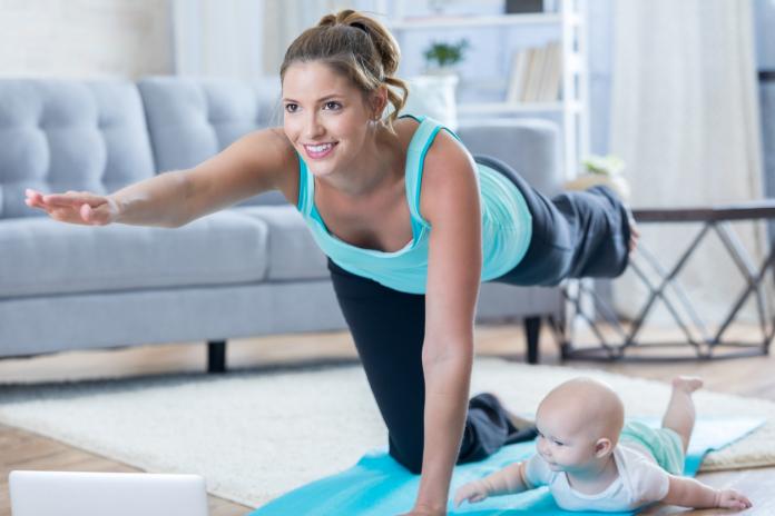 Mom and baby exercise together at home