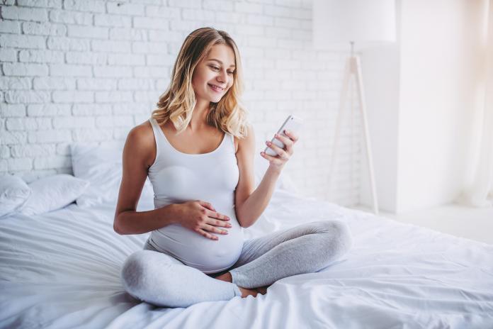 Pregnant in bed.