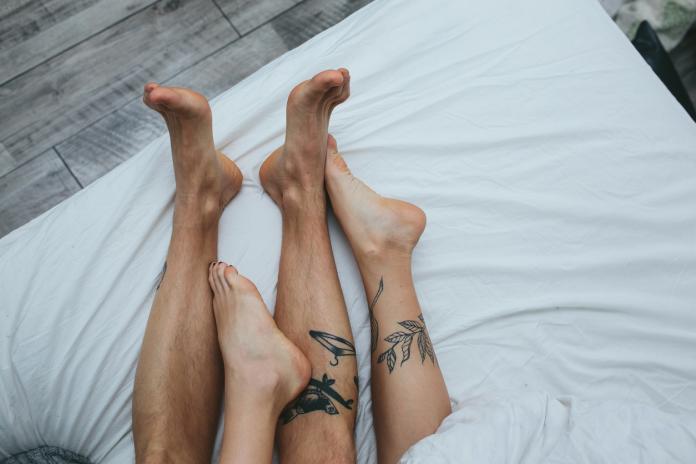 Young adult couple lying on bed