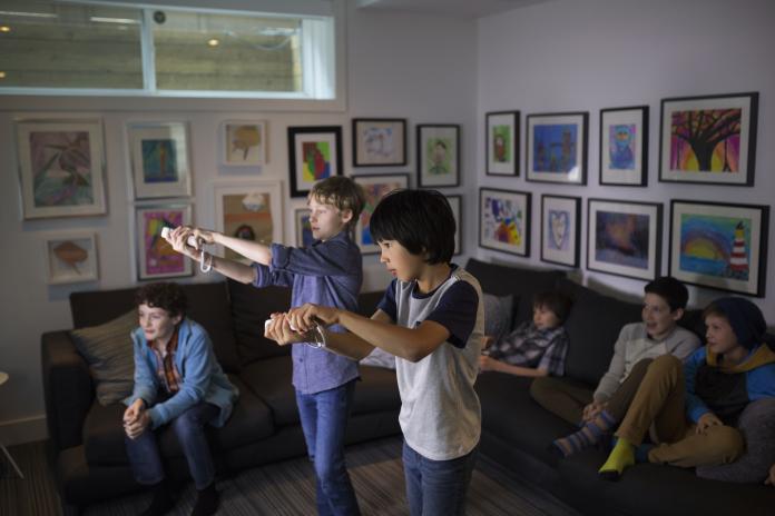 Boys playing video game in living room