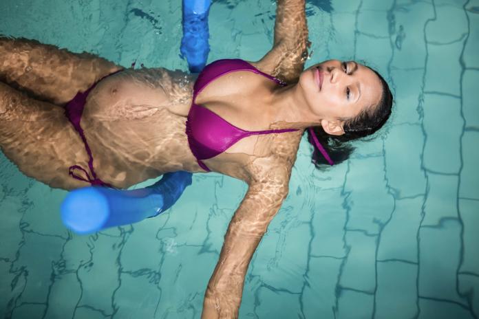 Pregnant woman with foam roller