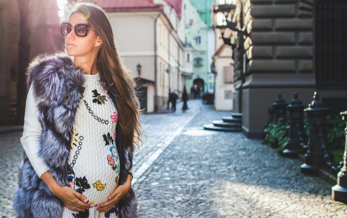 Beautiful pregnant woman walking.