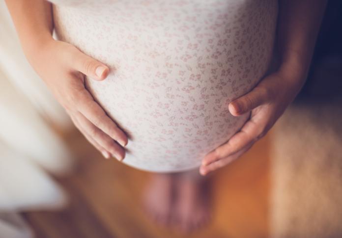 Pregnant woman touching her belly CMV