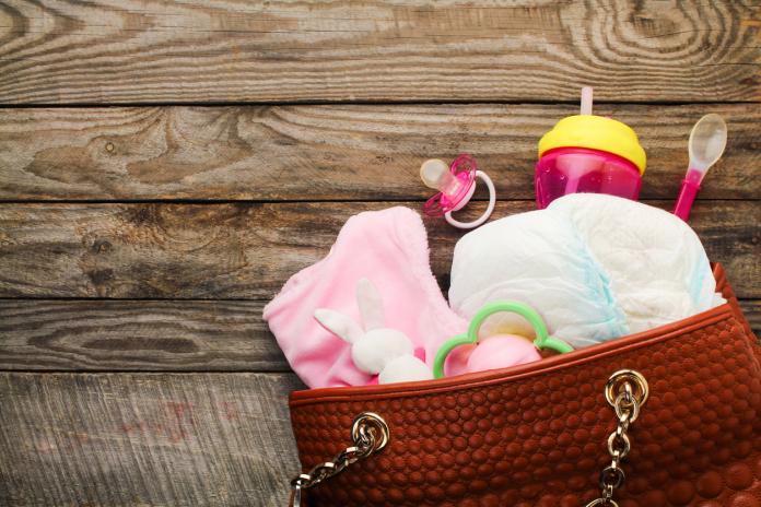Mother's handbag with items to care for child luiertas