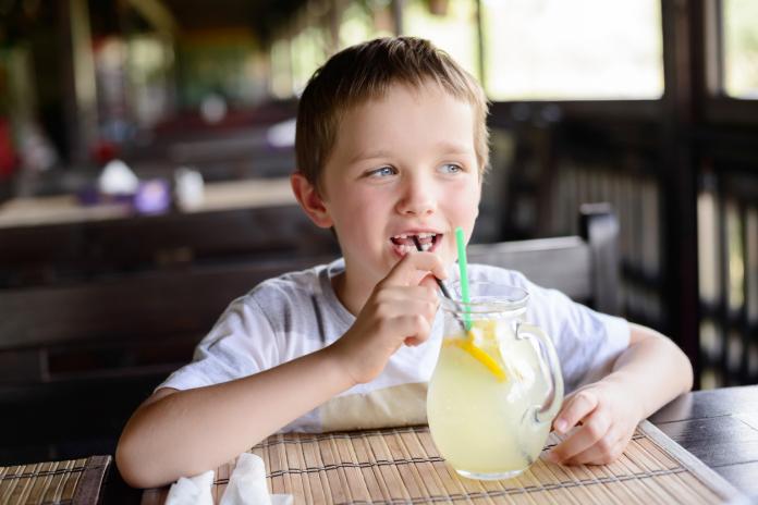 Little child boy enjoying his delicious lemonade DIY limonade