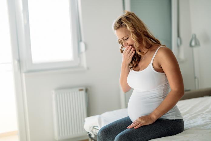 Portrait of blonde pregnant woman feeling sick