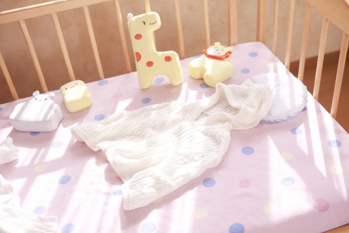 Crib, cardigan and stuffed animals