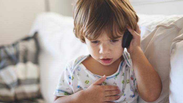 Small boy talking on mobile phone