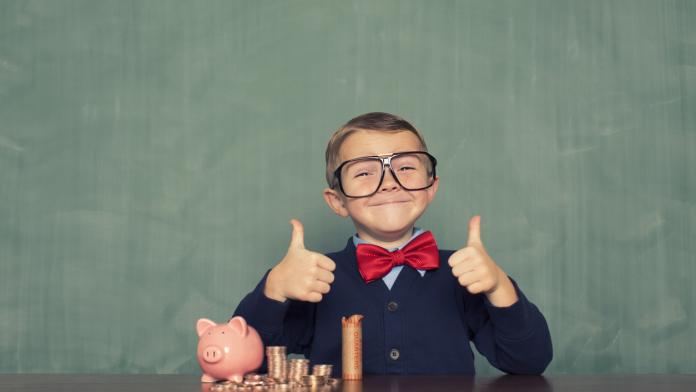 Young Boy Nerd Saves Money in His Piggy Bank