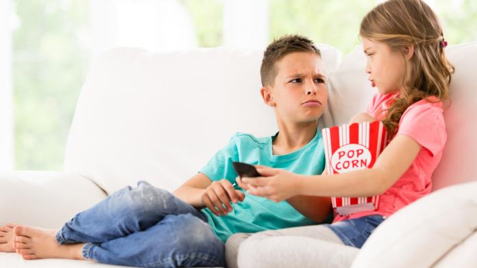 Children fighting over the TV remote