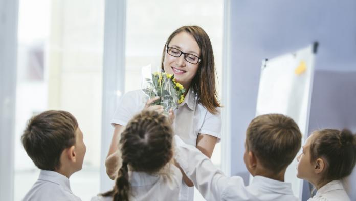 Beautiful children school children with flowers for the teachers at school