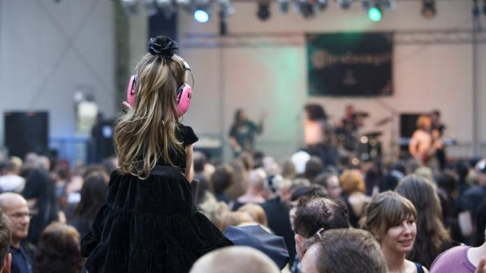little girl with ear protection on concert