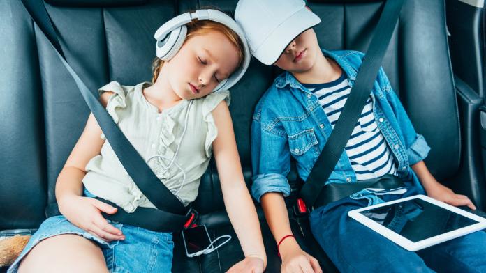 kids sleeping on backseats of car