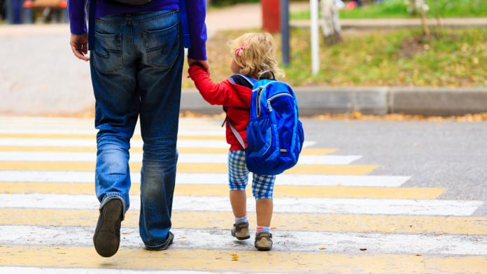 father with little daughter walking to school or daycare